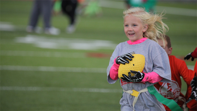 Girl running with a football