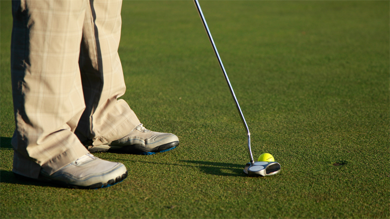Person about to hit a golf ball